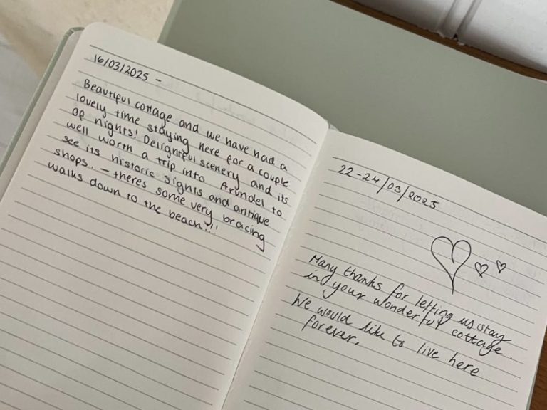 Open notebook with handwritten notes and a heart illustration on one page.